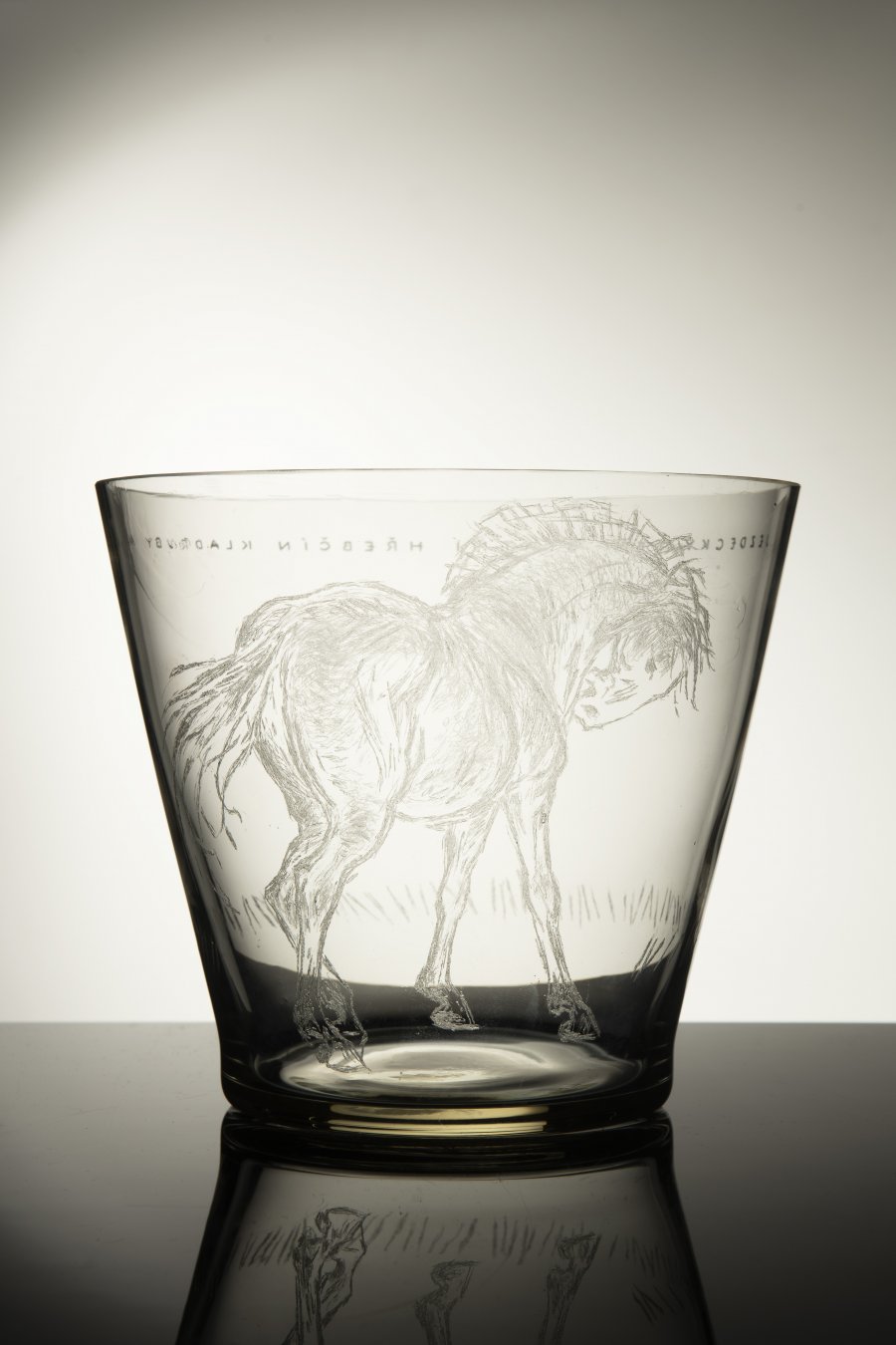 A VASE WITH A HORSE MOTIF