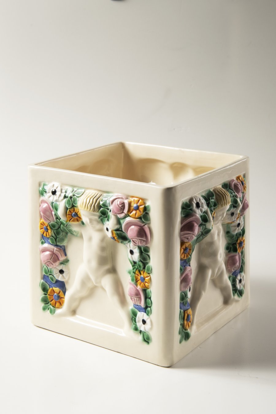 A FLOWER POT WITH PUTTI