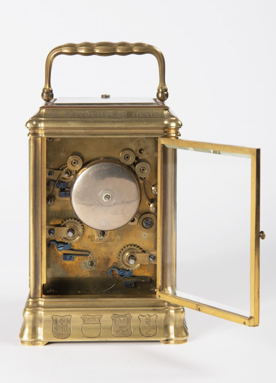 A TRAVEL ALARM CLOCK IN A CABINET