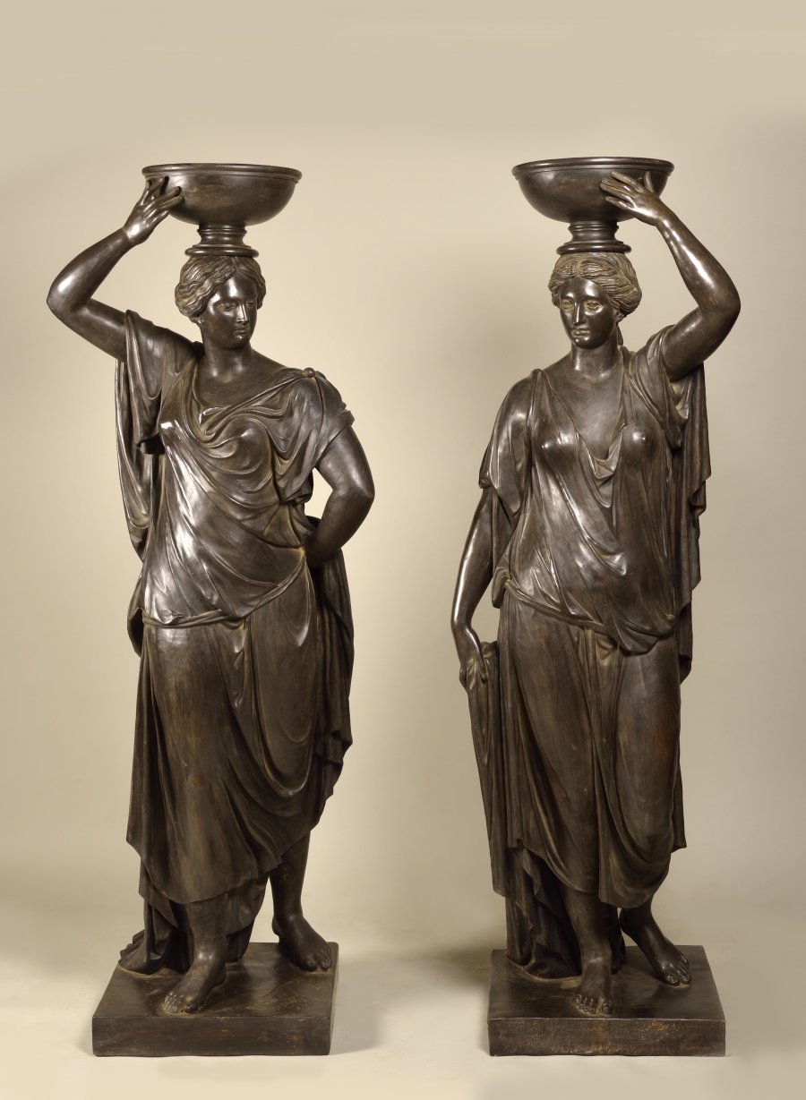 A PAIR OF CARYATIDS HOLDING A FLOWERPOT