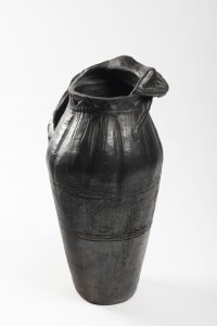 A VASE WITH A SCULPTURE