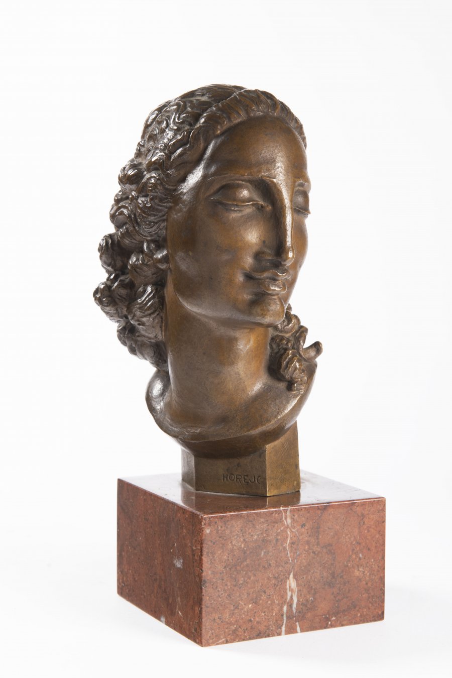 A HEAD OF A WOMAN WITH A RIBBON IN HER HAIR