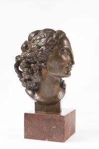 A HEAD OF A WOMAN WITH A RIBBON IN HER HAIR