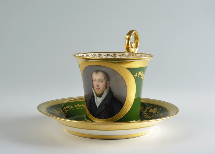 A PORTRAIT CUP AND SAUCER